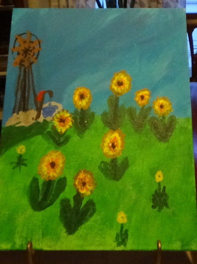 Wood windmill and sunflowers